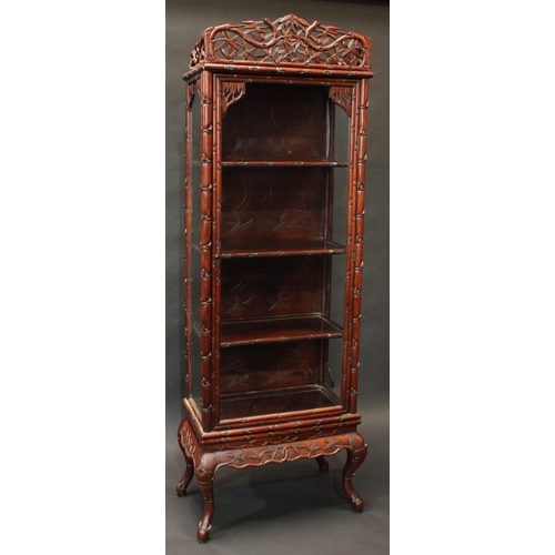 1421 - A Chinese hardwood display cabinet, pierced cresting above a glazed door enclosing three shelves, th... 