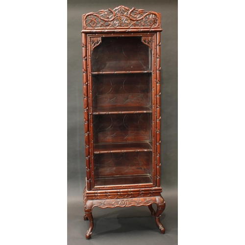 1421 - A Chinese hardwood display cabinet, pierced cresting above a glazed door enclosing three shelves, th... 