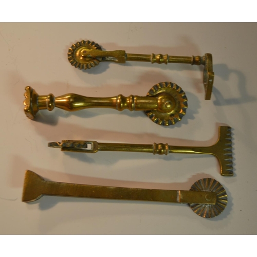 1441 - A collection of 19th century brass pastry jiggers, various forms, the largest 13.5cm long (10)