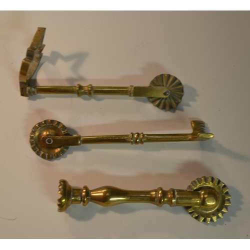 1441 - A collection of 19th century brass pastry jiggers, various forms, the largest 13.5cm long (10)