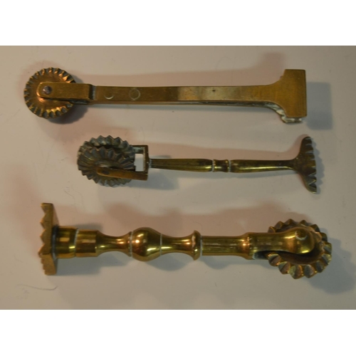 1441 - A collection of 19th century brass pastry jiggers, various forms, the largest 13.5cm long (10)