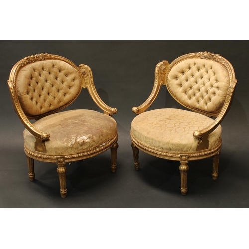 1445 - A pair of 19th century French giltwood boudoir window seats, oval backs carved with ribbon-tied palm... 