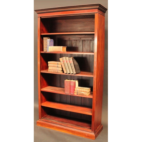 1461 - A 'Edwardian' walnut open bookcase, dentil cornice above adjustable shelves, plinth base, 208cm high... 