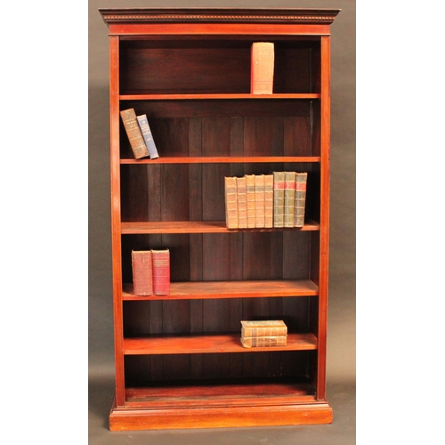 1461 - A 'Edwardian' walnut open bookcase, dentil cornice above adjustable shelves, plinth base, 208cm high... 