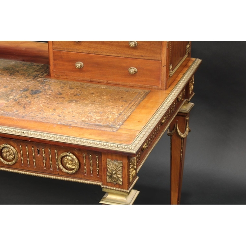 1464 - A Franglias Louis XVI Revival gilt metal mounted mahogany desk, inverted break-centre superstructure... 