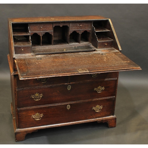 1484 - A George II oak bureau, fall front enclosing a stepped interior with well, above two short and two l... 