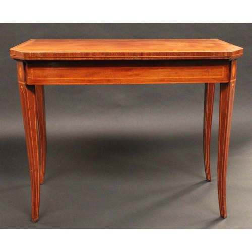 1505 - A George III mahogany canted rectangular card table, folding crossbanded top enclosing an inset baiz... 