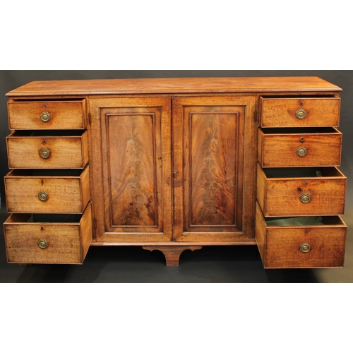 1511 - A George III mahogany low housekeeper's or press cupboard, in the manner of Gillows, rectangular top... 