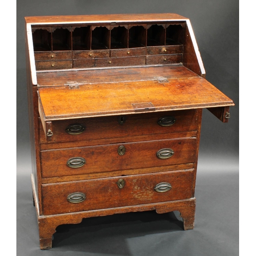 1528 - A George III oak bureau, of narrow proportions, fall front enclosing pigeonholes and small drawers a... 