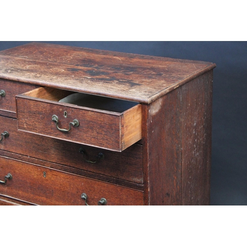 1529 - A George III oak chest, slightly oversailing top above two short and three long graduated cockbeaded... 