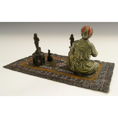 1560 - Austrian School (20th century), a cold-painted bronze, of a carpet seller, seated he proffers Egypti... 