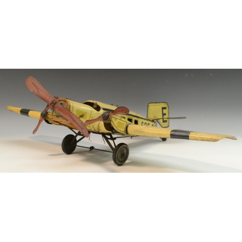 1569 - A German tinplate aeroplane, by Gunthermann, lithographed in black and yellow on a straw coloured gr... 