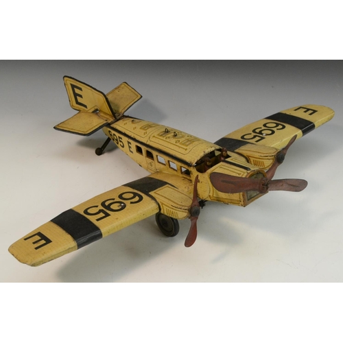 1569 - A German tinplate aeroplane, by Gunthermann, lithographed in black and yellow on a straw coloured gr... 