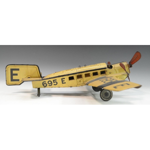 1569 - A German tinplate aeroplane, by Gunthermann, lithographed in black and yellow on a straw coloured gr... 