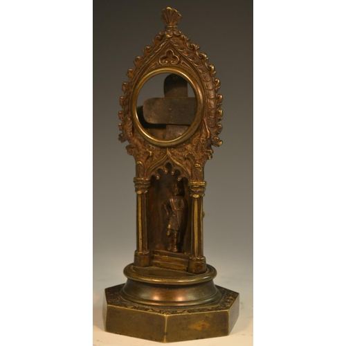 1571 - A Gothic Revival dark patinated bronze pocket watch stand, cast with a chivalric knight within a nic... 