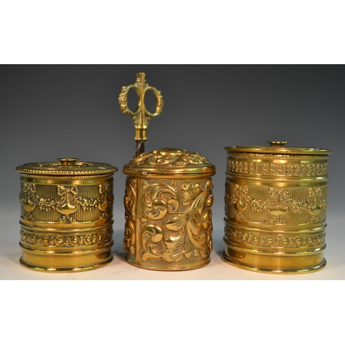 1596 - A late 19th century brass cylindrical string box, repousse embossed with scrolling  acanthus, scisso... 