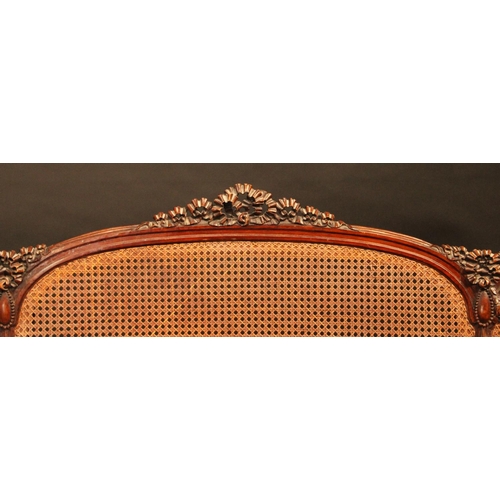 1619 - A Louis XVI Revival mahogany double bed, the caned head and footboard carved with ribbon cresting an... 