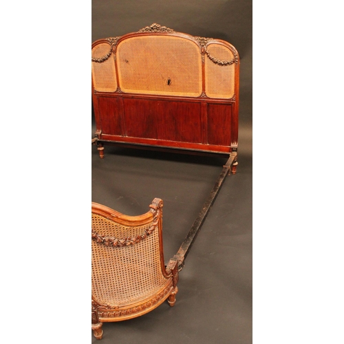 1619 - A Louis XVI Revival mahogany double bed, the caned head and footboard carved with ribbon cresting an... 