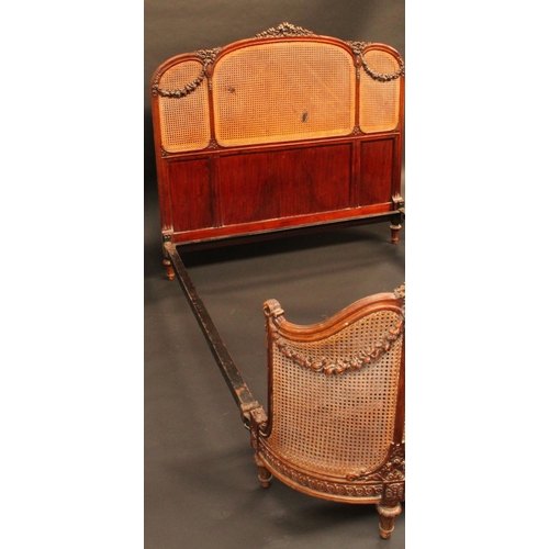 1619 - A Louis XVI Revival mahogany double bed, the caned head and footboard carved with ribbon cresting an... 