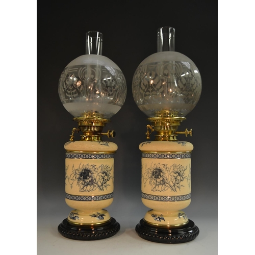 1642 - A pair 19th century stoneware table oil lamps, each decorated in the Aesthetic Movement taste with s... 