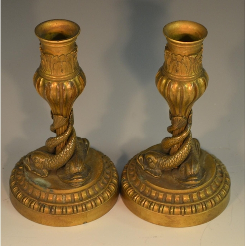 1652 - A pair of 19th century bronze candlesticks, each cast with three dolphins, acanthus-grasped sconces,... 