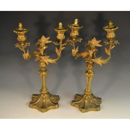 1657 - A pair of 19th century ormolu two-light table candlesticks, cast with leafy scrolls, fluted columns,... 