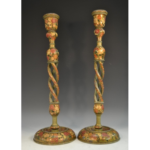 1676 - A pair of large Kashmiri open-twist table candlesticks, typically decorated in polychrome and gilt w... 