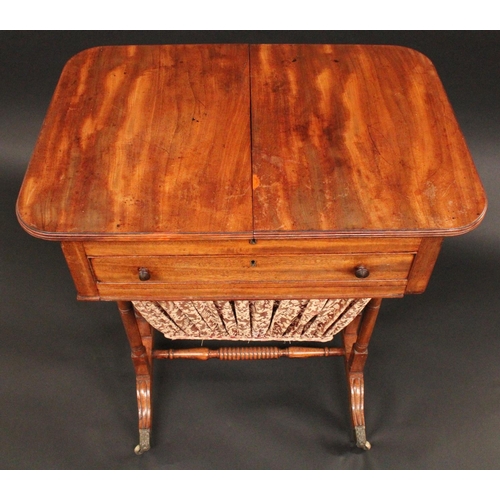 1705 - A Regency mahogany rounded rectangular work table, the sliding reeded top parting to reveal an arran... 