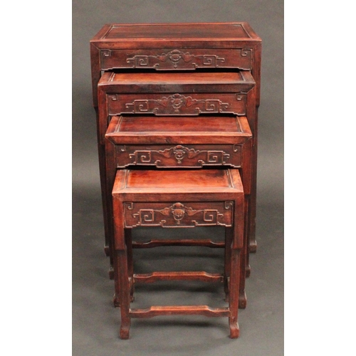 1715 - A set of Chinese hardwood quartetto tables, each with panelled top above a deep frieze carved with b... 