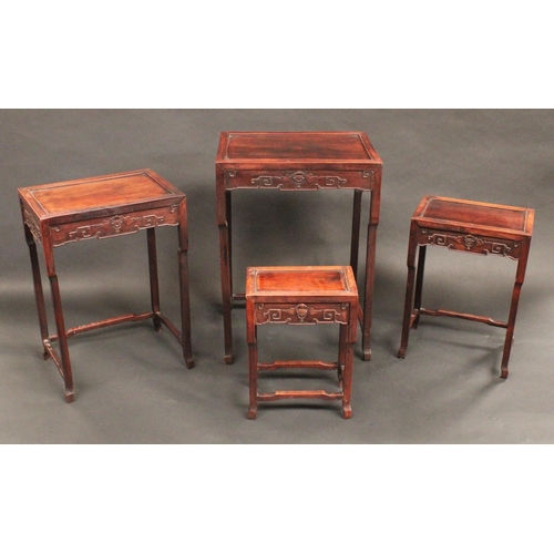 1715 - A set of Chinese hardwood quartetto tables, each with panelled top above a deep frieze carved with b... 