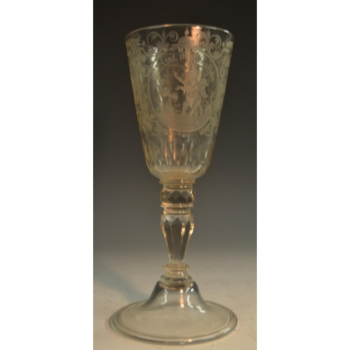 191 - A 19th century Bohemain glass goblet, etched and engraved with roundels of amorini, each enclosing a... 