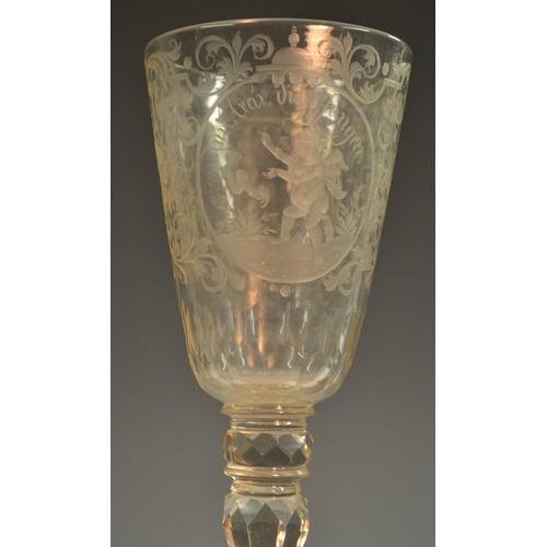 191 - A 19th century Bohemain glass goblet, etched and engraved with roundels of amorini, each enclosing a... 