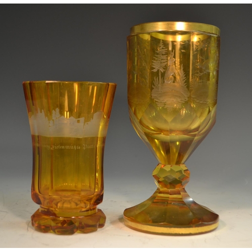 192 - A 19th century Bohemian amber glass octagonal goblet, etched and engraved with Black Forest game, gi... 