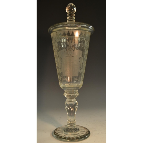 193 - A 19th century Bohemian glass armorial pedestal goblet and cover, the fluted tapering bowl boldly et... 