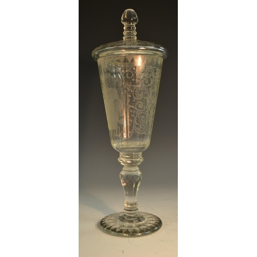 193 - A 19th century Bohemian glass armorial pedestal goblet and cover, the fluted tapering bowl boldly et... 