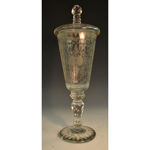 193 - A 19th century Bohemian glass armorial pedestal goblet and cover, the fluted tapering bowl boldly et... 