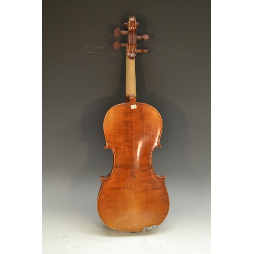 2065 - A violin, the two-piece back 36cm long excluding button, outlined throughout with purfling, paper St... 