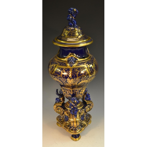 232 - A 19th century French earthenware vase and cover, glazed in Mazarin blue and richly decorated in gil... 