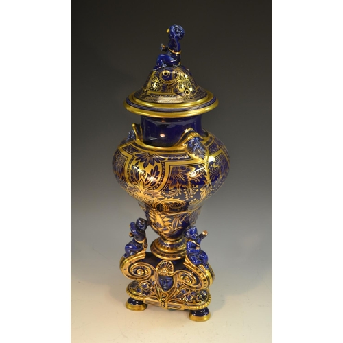 232 - A 19th century French earthenware vase and cover, glazed in Mazarin blue and richly decorated in gil... 