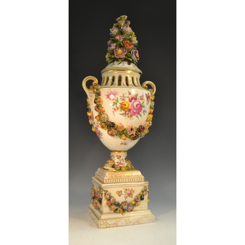 233 - A 19th century German porcelain urnular pedestal vase and cover, painted with Deutsche Blumen and ap... 