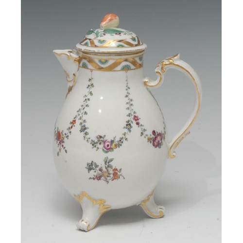 259 - An 18th century Ludwigsburg three footed jug and cover,  painted with swags of flowers, scroll feet,... 