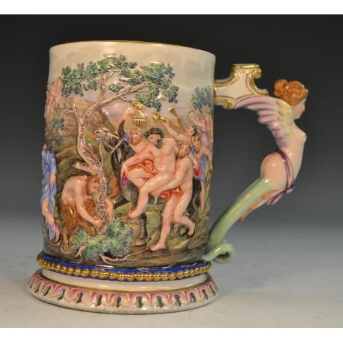 263 - An Italian porcelain mug, moulded in relief and brightly decorated with a scene from Classical mytho... 