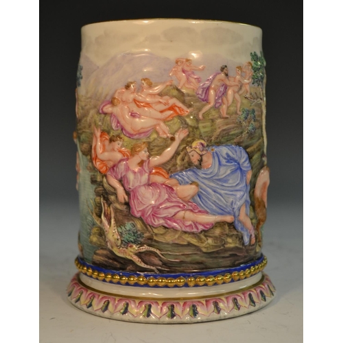 263 - An Italian porcelain mug, moulded in relief and brightly decorated with a scene from Classical mytho... 