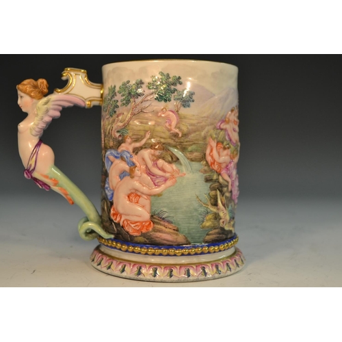 263 - An Italian porcelain mug, moulded in relief and brightly decorated with a scene from Classical mytho... 