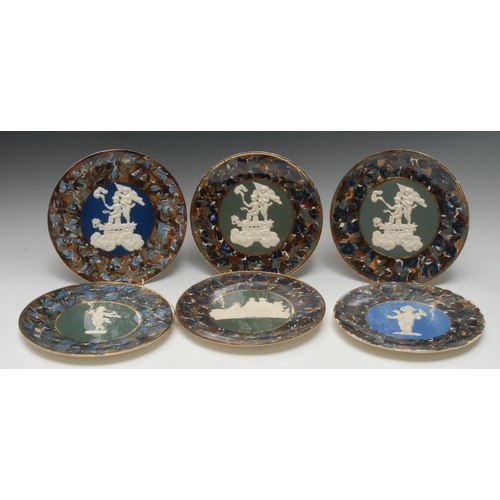 27 - A pair of Thomas Fradley circular plates, applied in white relief with cherubs on a cart, marbled bo... 