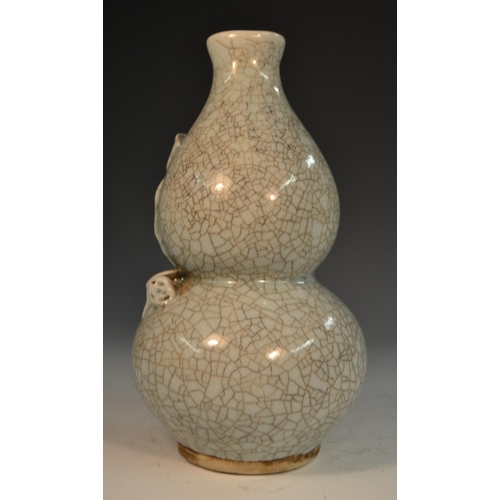 289 - A Chinese crackle glaze celadon double gourd vase, moulded and applied with peach blossom, 21cm high