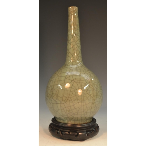 290 - A Chinese crackle glaze celadon ovoid bottle vase, 24cm high, 19th century, hardwood stand