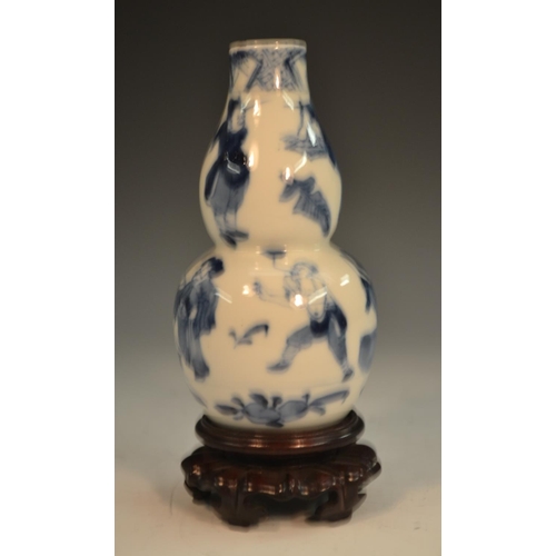 291 - A Chinese double gourd vase, painted in tones of underglaze blue with the Hundred Boys, 13.5cm high,... 