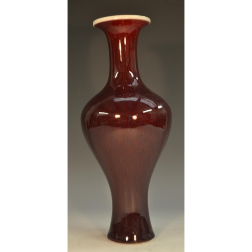 294 - A Chinese monochrome bulbous baluster vase, glazed in tones of sang de beouf, 29cm high