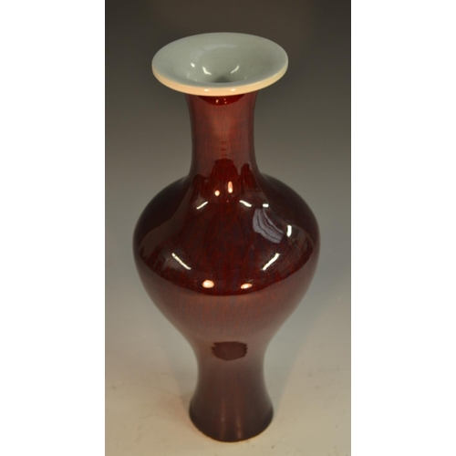 294 - A Chinese monochrome bulbous baluster vase, glazed in tones of sang de beouf, 29cm high